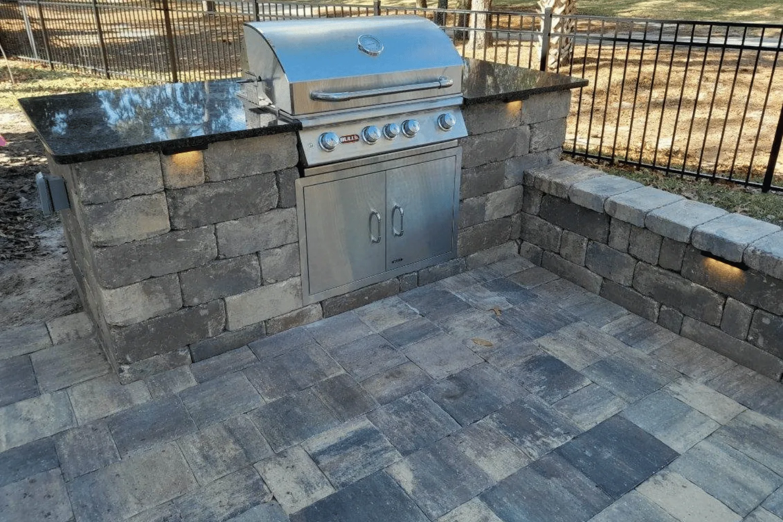 Built-in grill island installation on stone veneer base with paver patio by Jax Pavers in Jacksonville FL