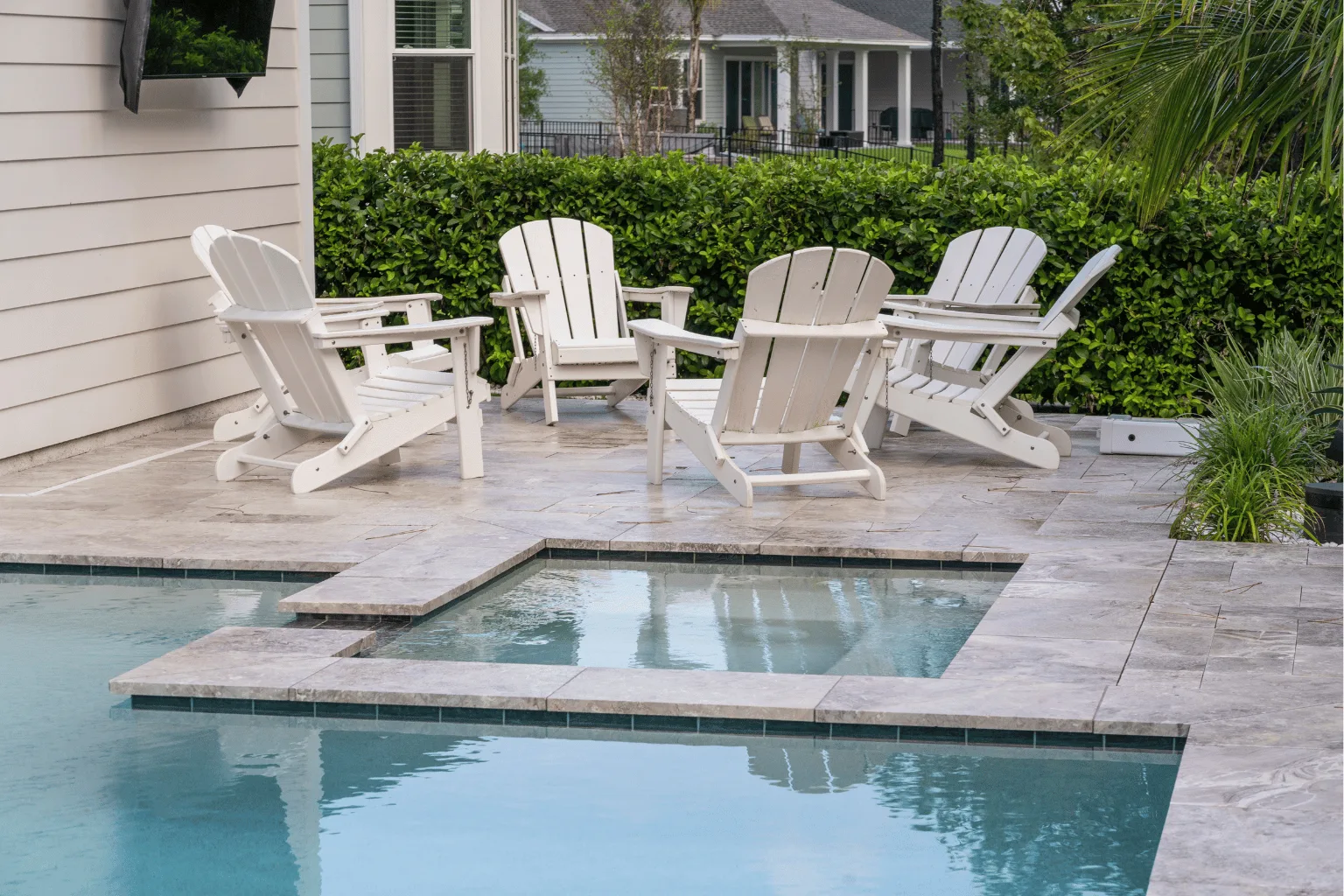 Travertine pool deck installation with geometric spa surround by Jax Pavers in Jacksonville FL
