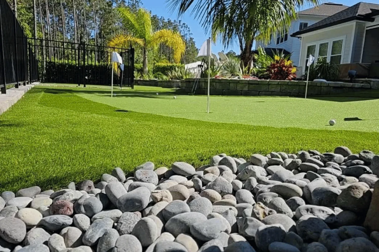 Backyard putting green and paver retaining wall installation by Jax Pavers in Jacksonville FL