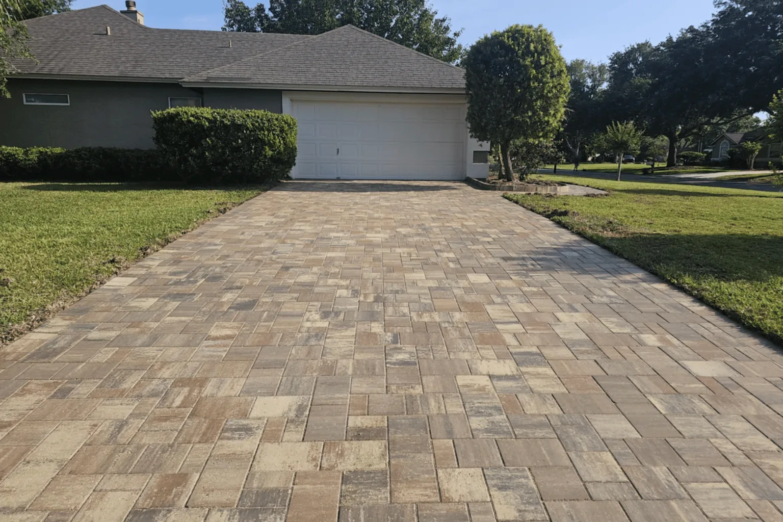 Straight-lay paver driveway installation in natural earth tones by Jax Pavers in Jacksonville FL