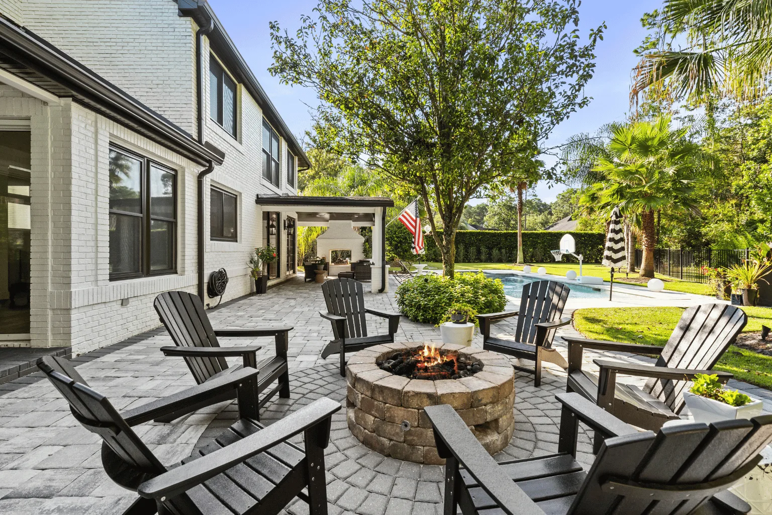 Paver patio installation with fire pit and poolside pergola by Jax Pavers in Jacksonville FL