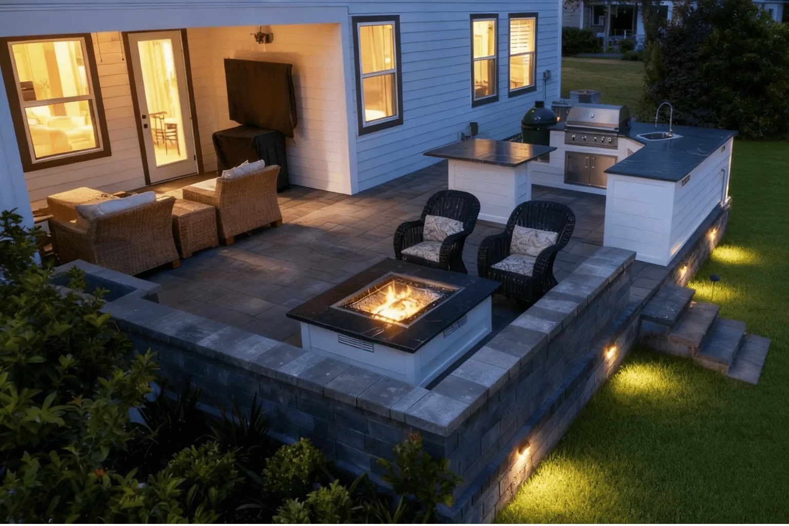 Elevated paver patio installation with fire pit, outdoor kitchen, and accent lighting by Jax Pavers in Jacksonville FL