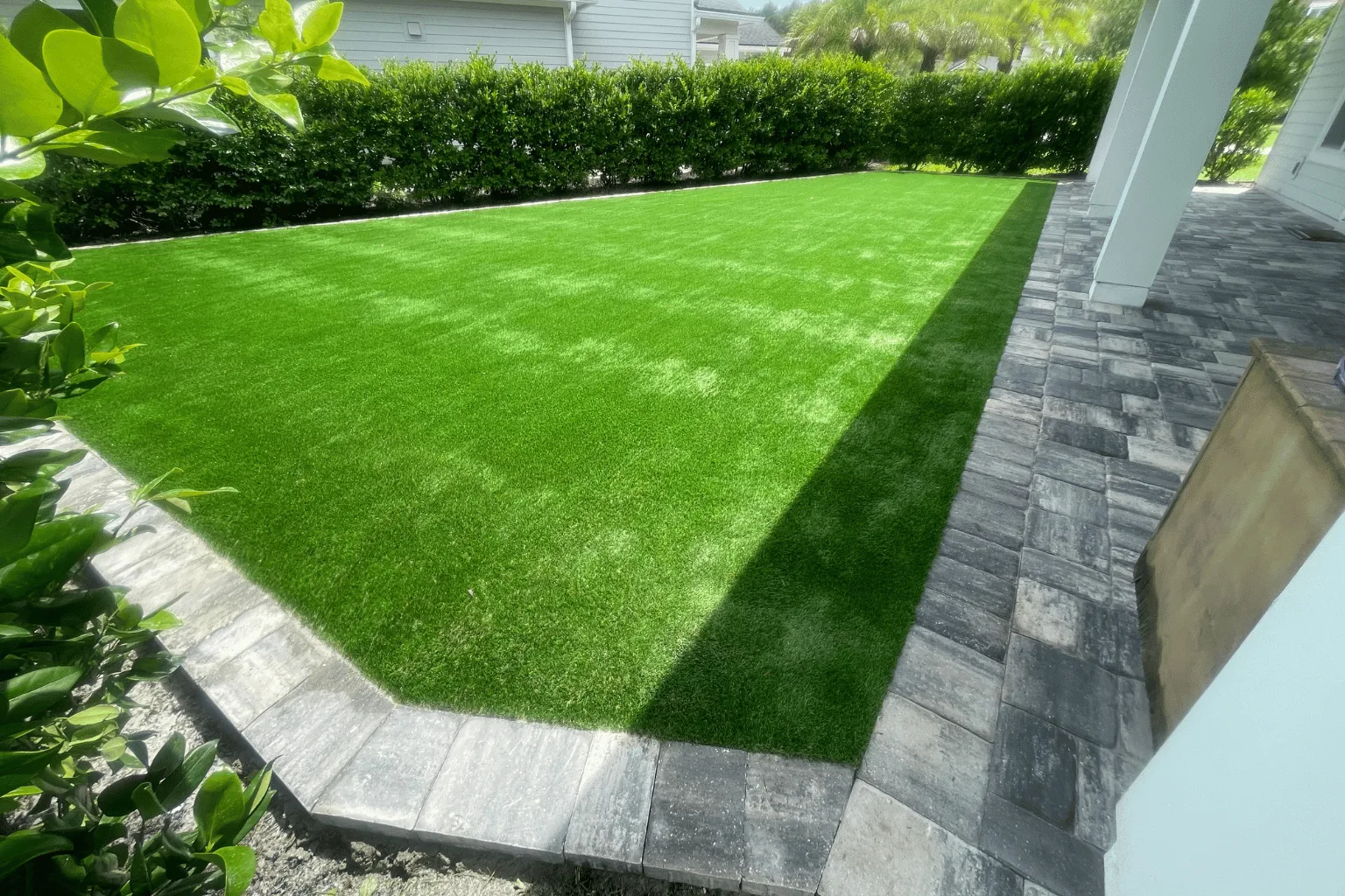 Artificial turf and paver border installation by Jax Pavers in Jacksonville FL