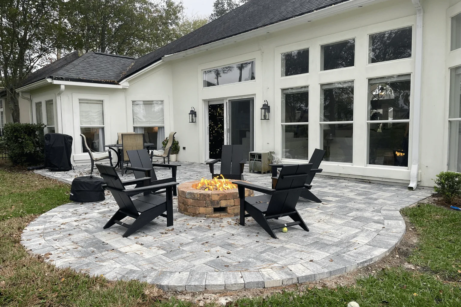 Backyard paver patio installation with circular fire pit by Jax Pavers in Jacksonville FL